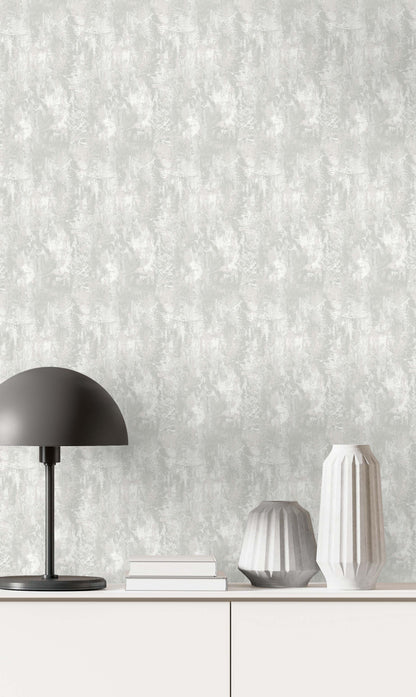 Minimalist scene with a black lamp, books, and vases on a white cabinet against Faux Concrete Wallpaper.