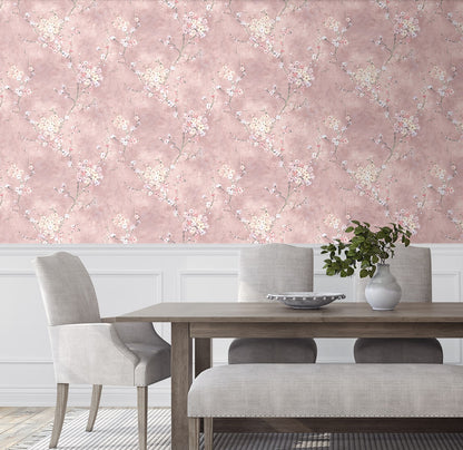 Dining room with wall decorated with Pink Blossom Branch Peel & Stick Casa Mia Wallcovering, wooden table, and gray chairs.