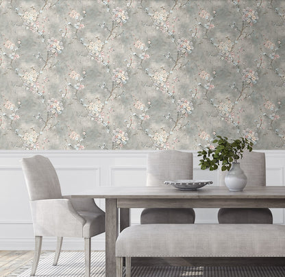 Dining room with wall decorated with Gray Blossom Branch Peel & Stick Casa Mia Wallcovering, wooden table, and gray chairs.