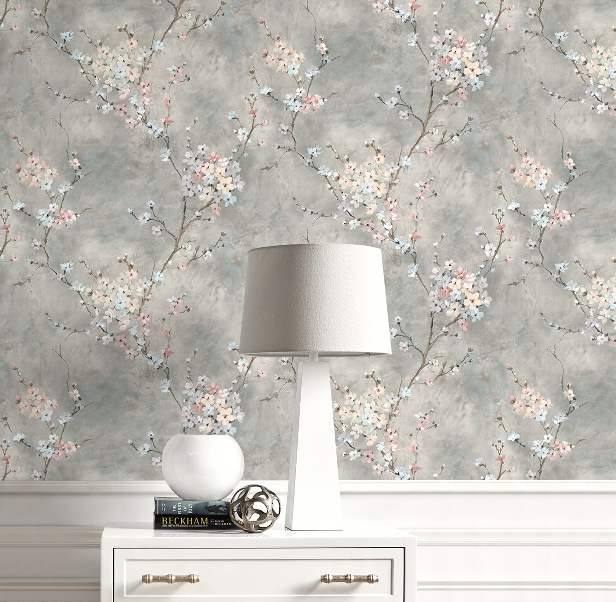Lamp on a white dresser with Gray Blossom Branch Peel & Stick Casa Mia Wallcovering on the background.
