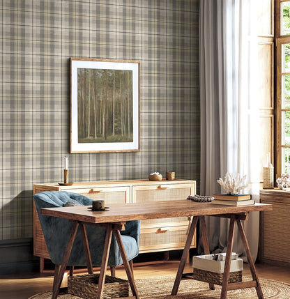Home office with wooden desk, wall decorated with Light Gray Tailored Plaid Peel & Stick Casa Mia Wallcovering., and framed artwork.