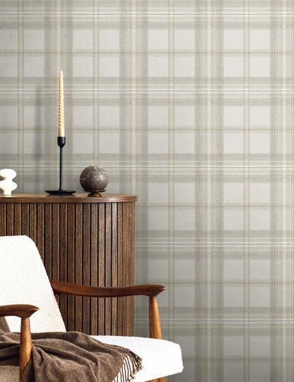 Armchair with wooden furniture next to it with ornaments against a wall decorated with Gray Broken Twill Plaid Peel & Stick Casa Mia Wallcovering.