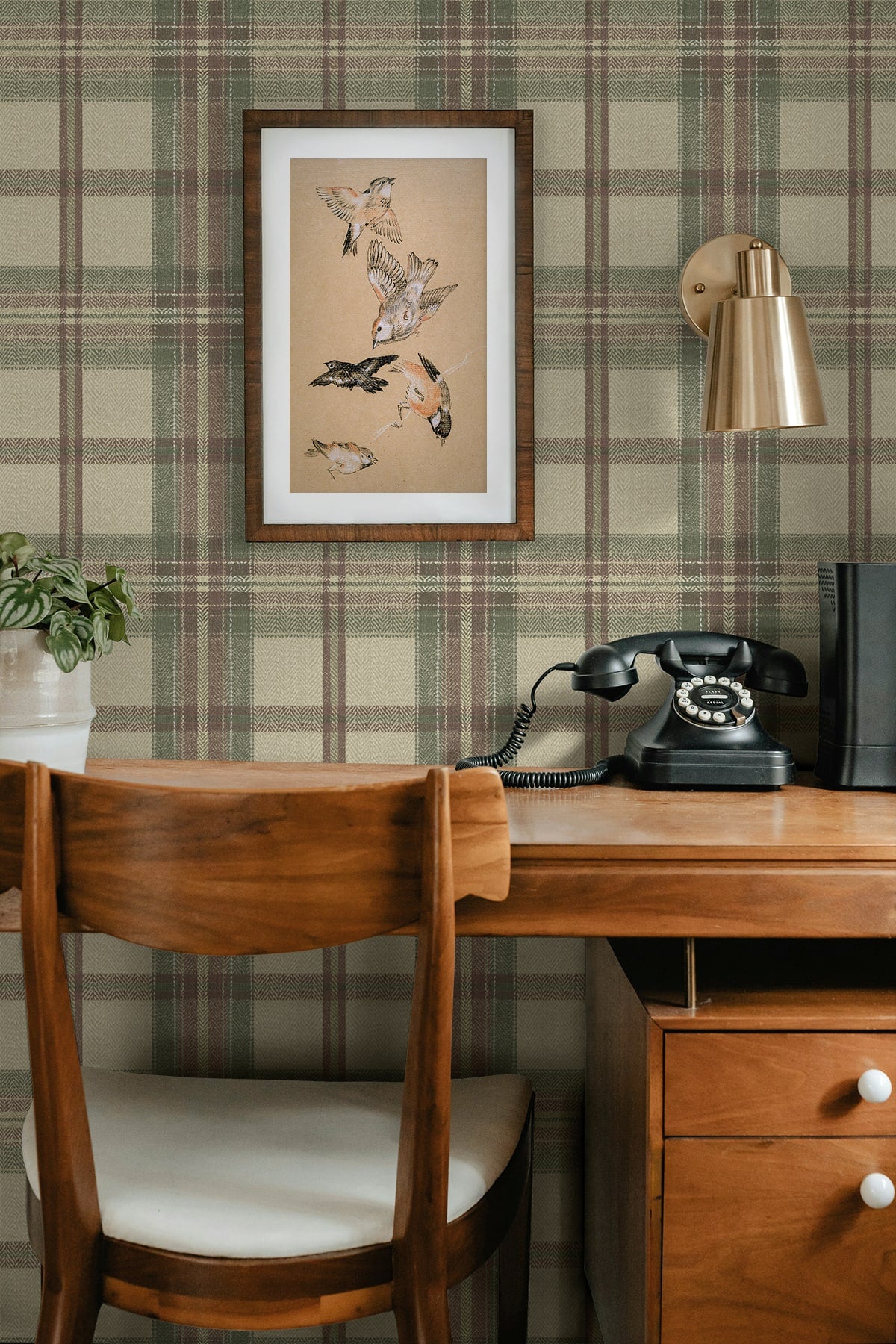 Wooden desk with chair, framed artwork, and vintage telephone against a wall decorated with Multicolor Greenish Broken Twill Plaid Peel & Stick Casa Mia Wallcovering.