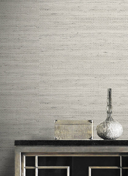 Wall decorated with Gray Weave Grasscloth Effect Peel & Stick Casa Mia Wallcovering and decorative elements including a vase and box.