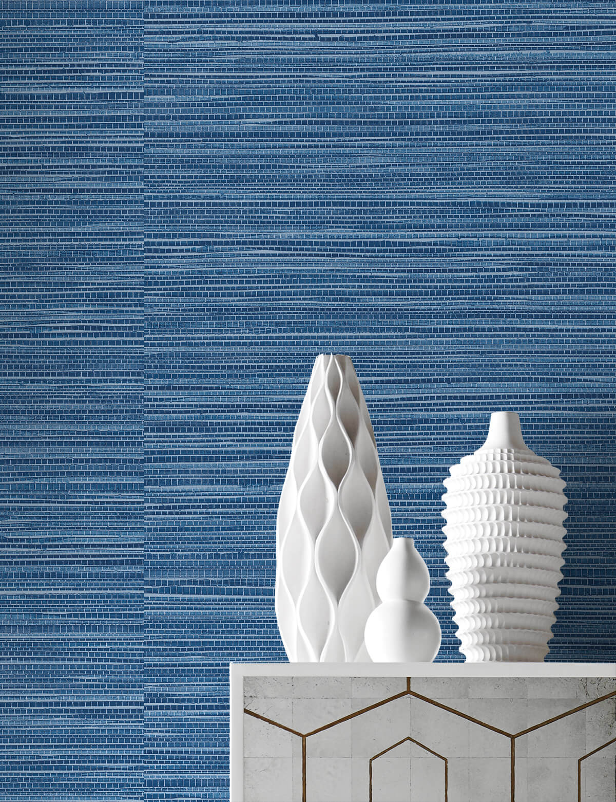 White ceramic vases on a marble surface with Blue Faux Sisal Peel & Stick Casa Mia Wallcovering in the background.