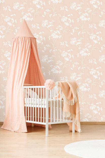 Baby in a crib with a pink canopy and Pink Soft Scent Floral Peel & Stick Casa Mia Wallcovering in the background.