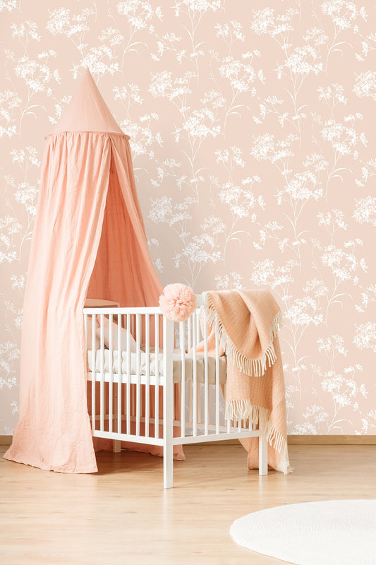 Baby in a crib with a pink canopy and Pink Soft Scent Floral Peel & Stick Casa Mia Wallcovering in the background.