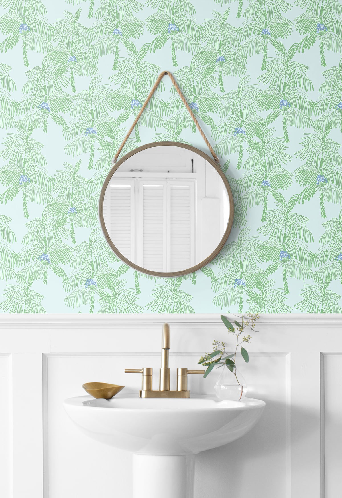 Bathroom with round mirror hanging on a Green Palm Peel & Stick Casa Mia Wallcovering.

