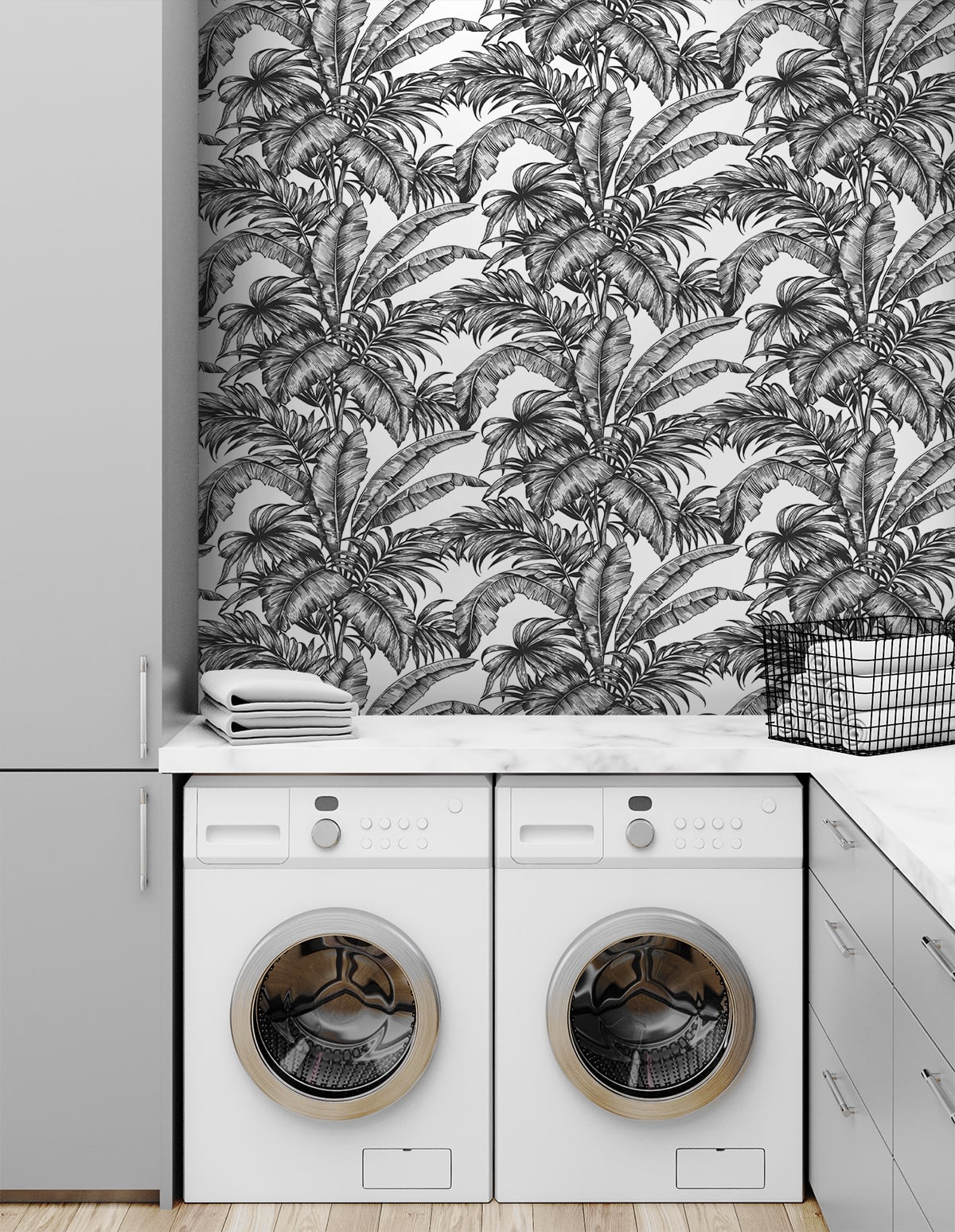 Laundry room with whitewashing machine and dryer against a wall decorated with Black Rainforest Palm Peel & Stick Casa Mia Wallcovering.