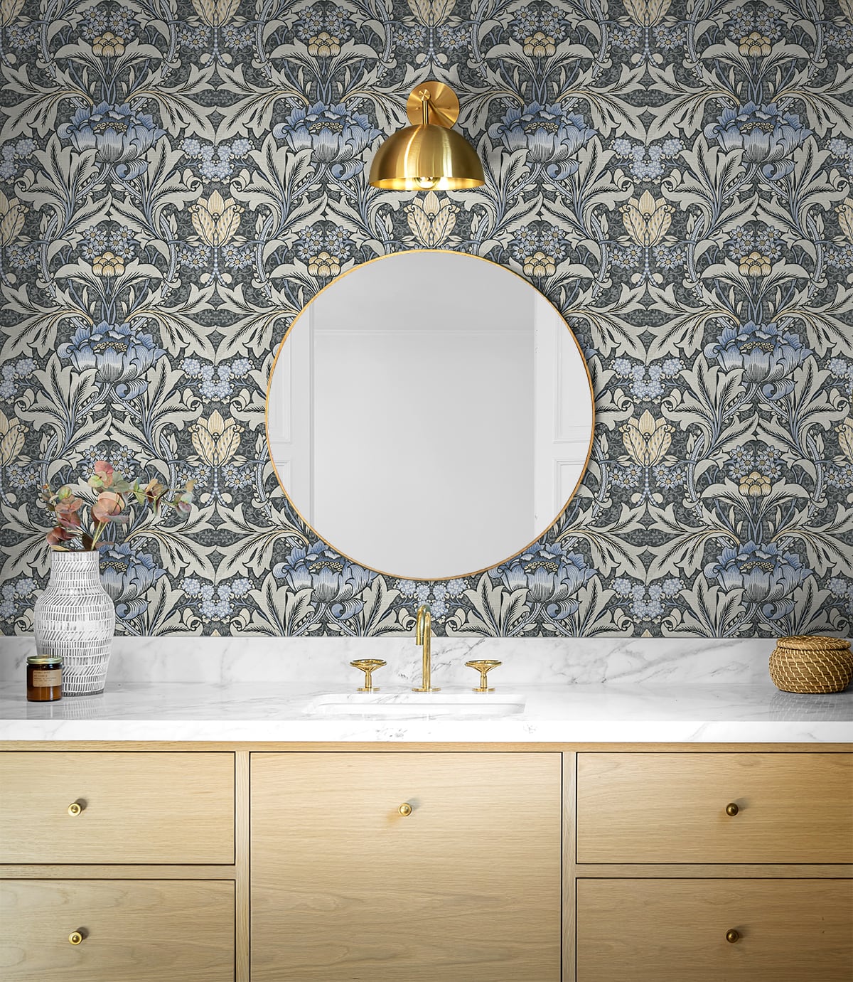 Bathroom with decorated with Black & Blue Bear's Breeches Peel & Stick Casa Mia Wallcovering, gold accents, and wooden vanity.