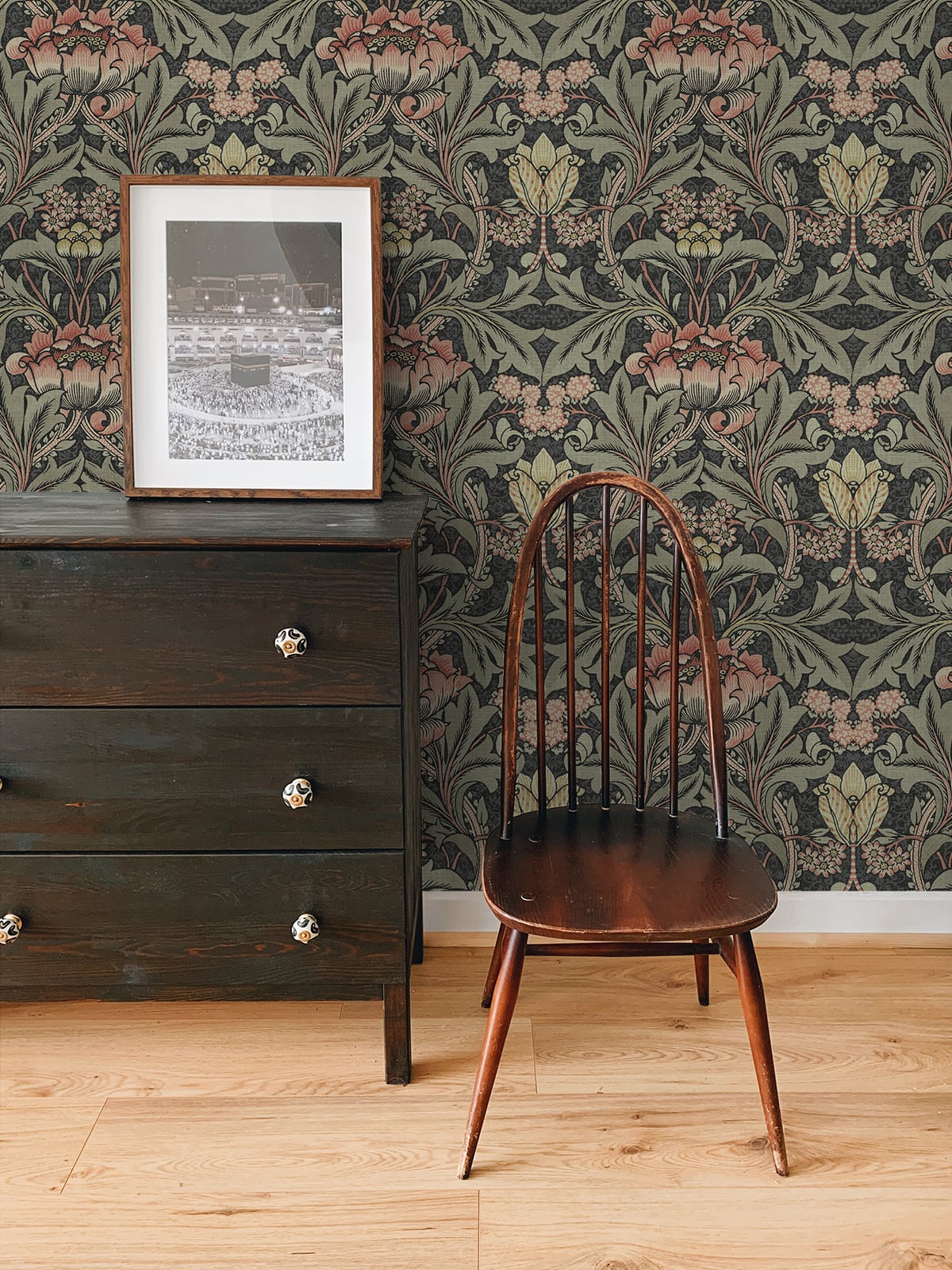 Wooden chair in front of a dresser with wall decorated with Black & Rose Bear's Breeches Peel & Stick Casa Mia Wallcovering.