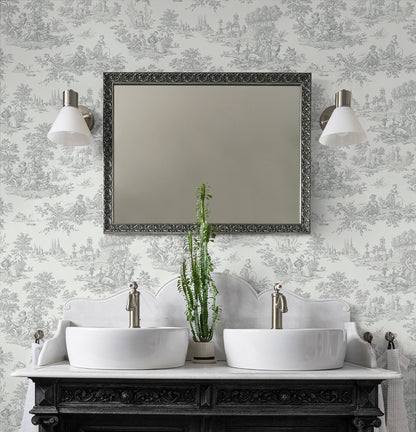 Bathroom vanity with two sinks, a mirror, and decorative wall lights against a wall decorated with Gray Toile de Jouy Peel & Stick Casa Mia Wallcovering.