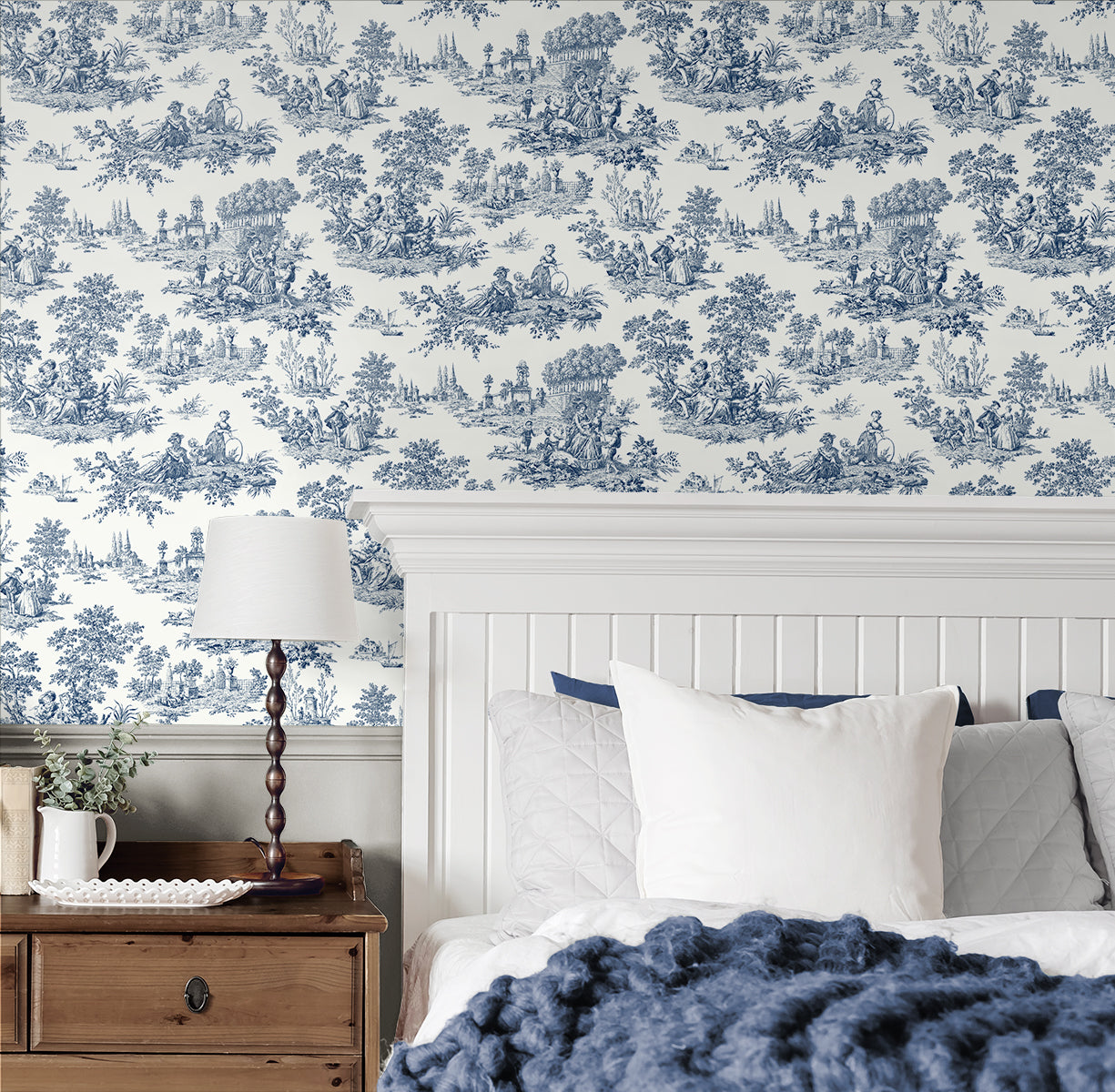 Bedroom wall decorated with Blue Toile de Jouy Peel & Stick Casa Mia Wallcovering, wooden nightstand, and bed with pillows and blanket.