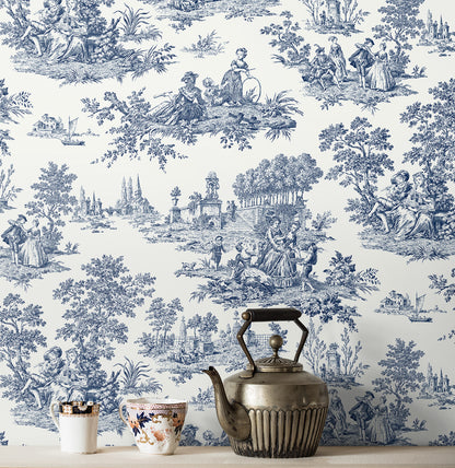 Vintage-style wallpaper with blue and white design featuring people and nature Blue Toile de Jouy Peel & Stick Casa Mia Wallcovering, with a teapot and cups in front.