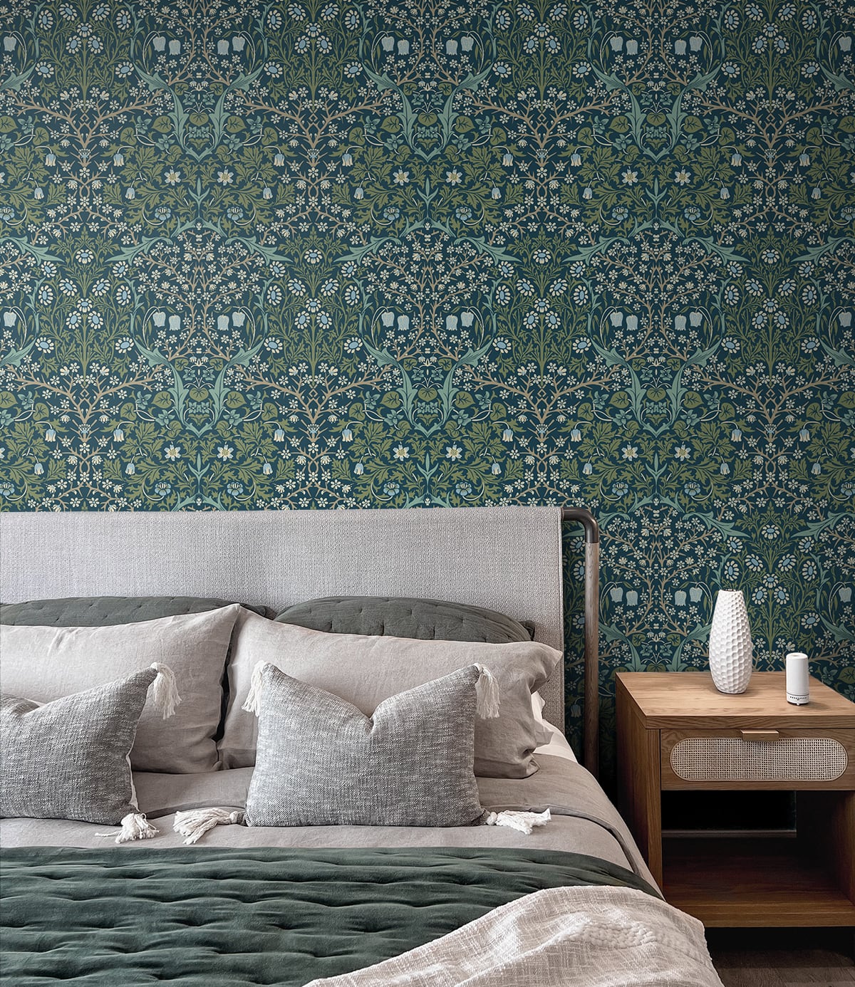 Bedroom with wall decorated with Blue & Green Victorian Floral Peel & Stick Casa Mia Wallcovering, bed with gray bedding, and wooden nightstand.