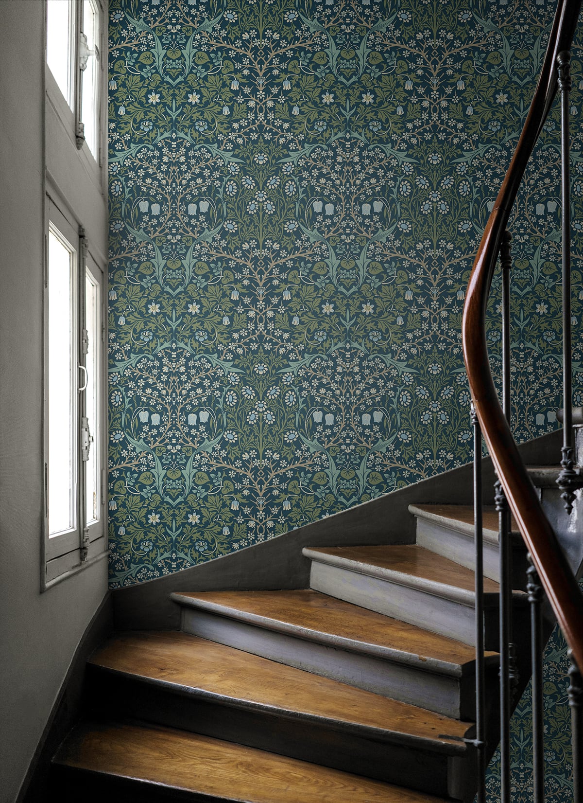 Staircase with wooden steps and a wall decorated with Blue & Green Victorian Floral Peel & Stick Casa Mia Wallcovering. 