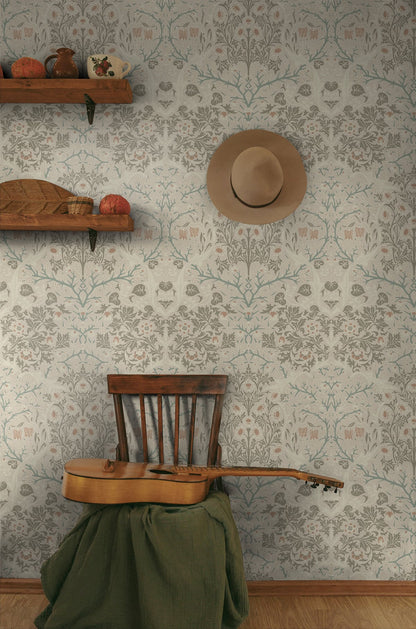 Wooden chair with a guitar draped over it against a wall decorated with Beige Victorian Floral Peel & Stick Casa Mia Wallcovering and with a hat hanging on the wall.