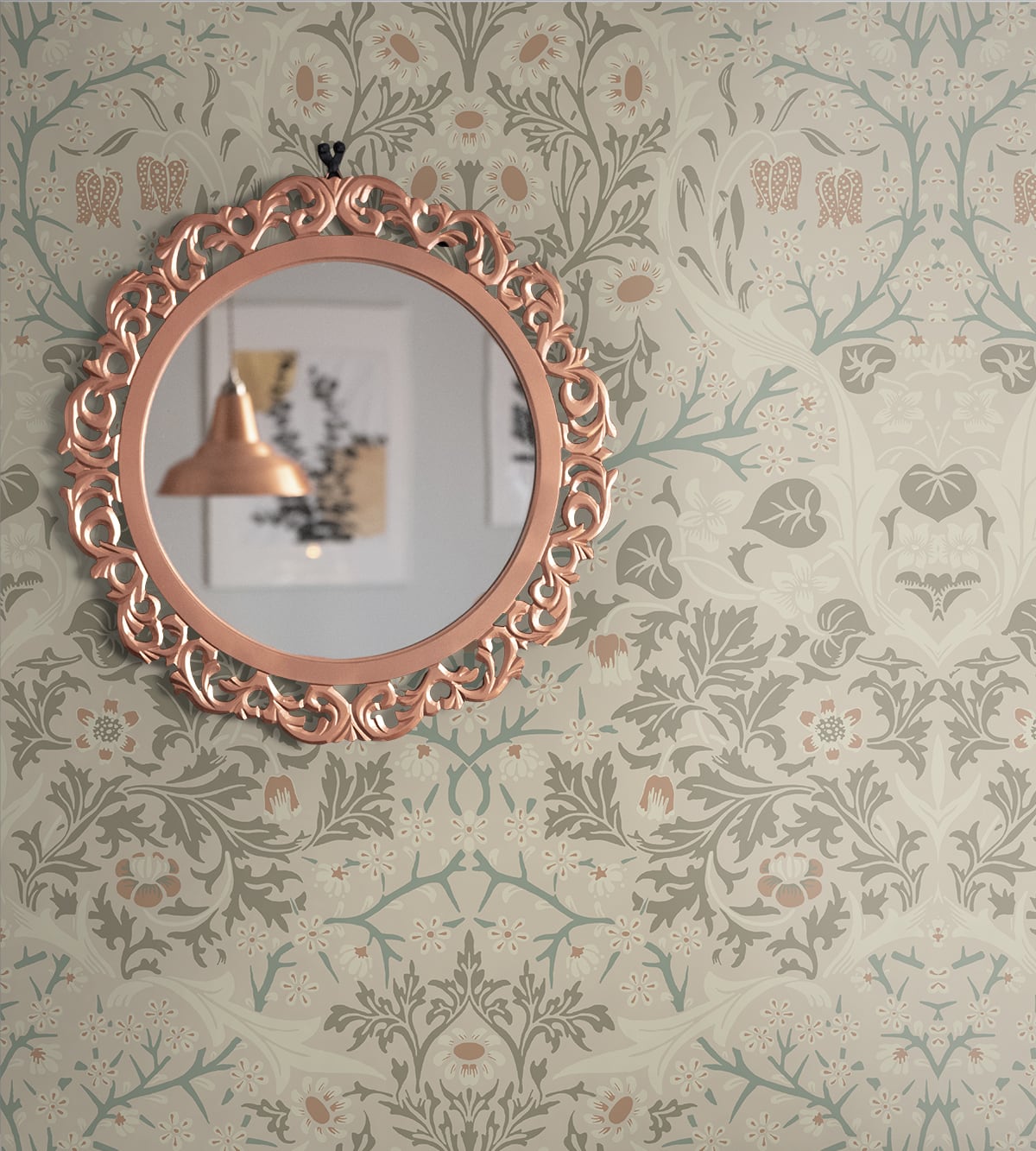Decorative round mirror with a rose gold frame on a wall decorated with Beige Victorian Floral Peel & Stick Casa Mia Wallcovering.
