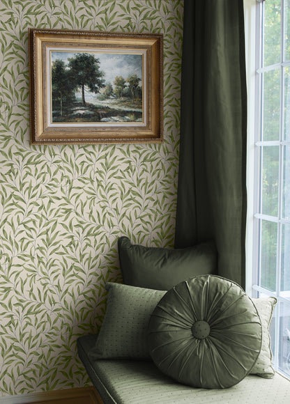 Green cushion on a bench against a wall with Green Leafy Branches Peel & Stick Casa Mia Wallcovering and a framed painting.