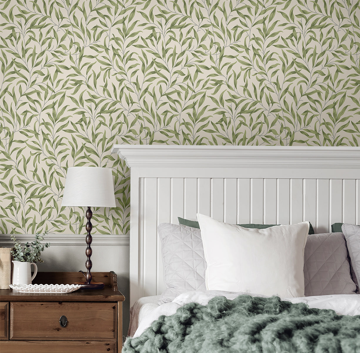 Bedroom with wall decorated with Green Leafy Branches Peel & Stick Casa Mia Wallcovering and wooden nightstand.