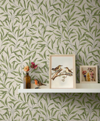 Wallpaper with leaf pattern Green Leafy Branches Peel & Stick Casa Mia Wallcovering, shelf with framed pictures and decorative items.