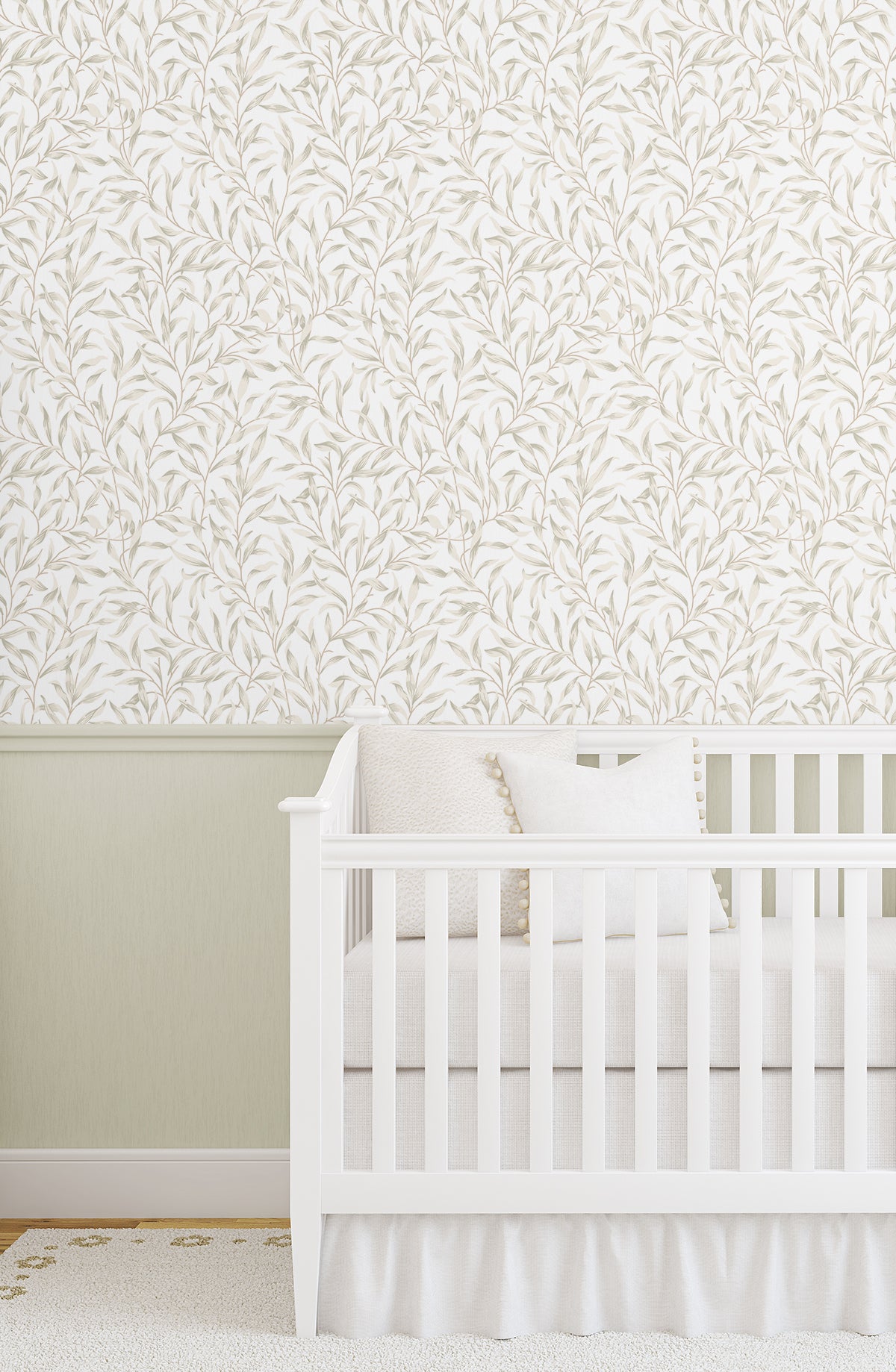 White crib in a room with wall decorated with Beige Leafy Branches Peel & Stick Casa Mia Wallcovering.