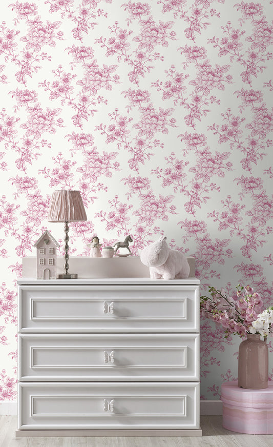 White dresser with decorative items against a wall decorated with Pink Cherished Rose Peel & Stick Casa Mia Wallcovering.
