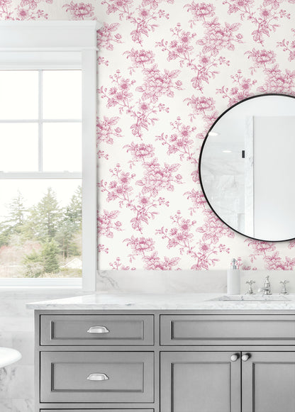 Bathroom wall decorated with Pink Cherished Rose Peel & Stick Casa Mia Wallcovering, gray vanity, and round mirror.
