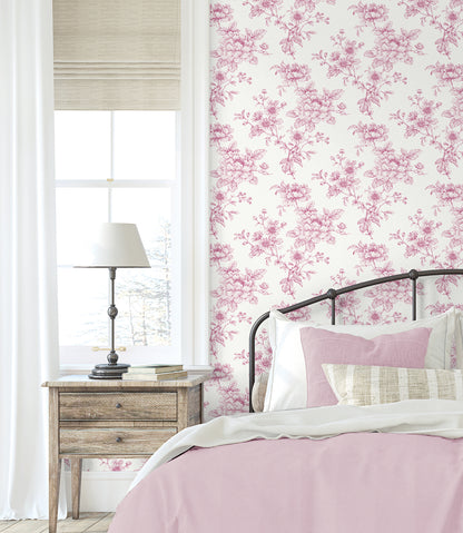 Bedroom wall decorated with Pink Cherished Rose Peel & Stick Casa Mia Wallcovering pink bedding, and wooden nightstand.