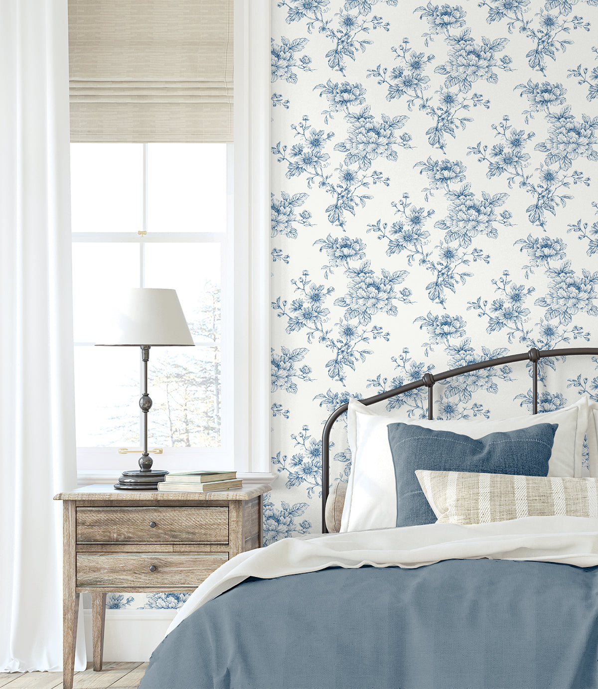 Bedroom wall decorated with Blue Cherished Rose Peel & Stick Casa Mia Wallcovering, wooden nightstand, and bed with blue bedding.