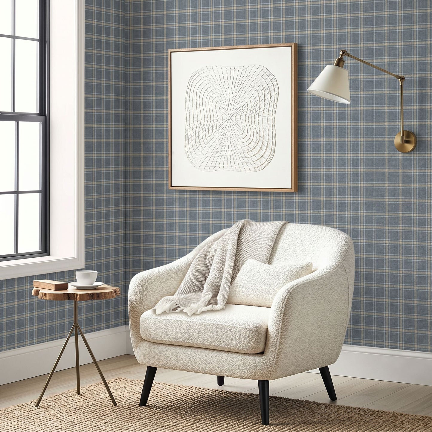 Cozy armchair with blanket, small round table, wall art, sconce, and Tartan Wallpaper in a country-style room.