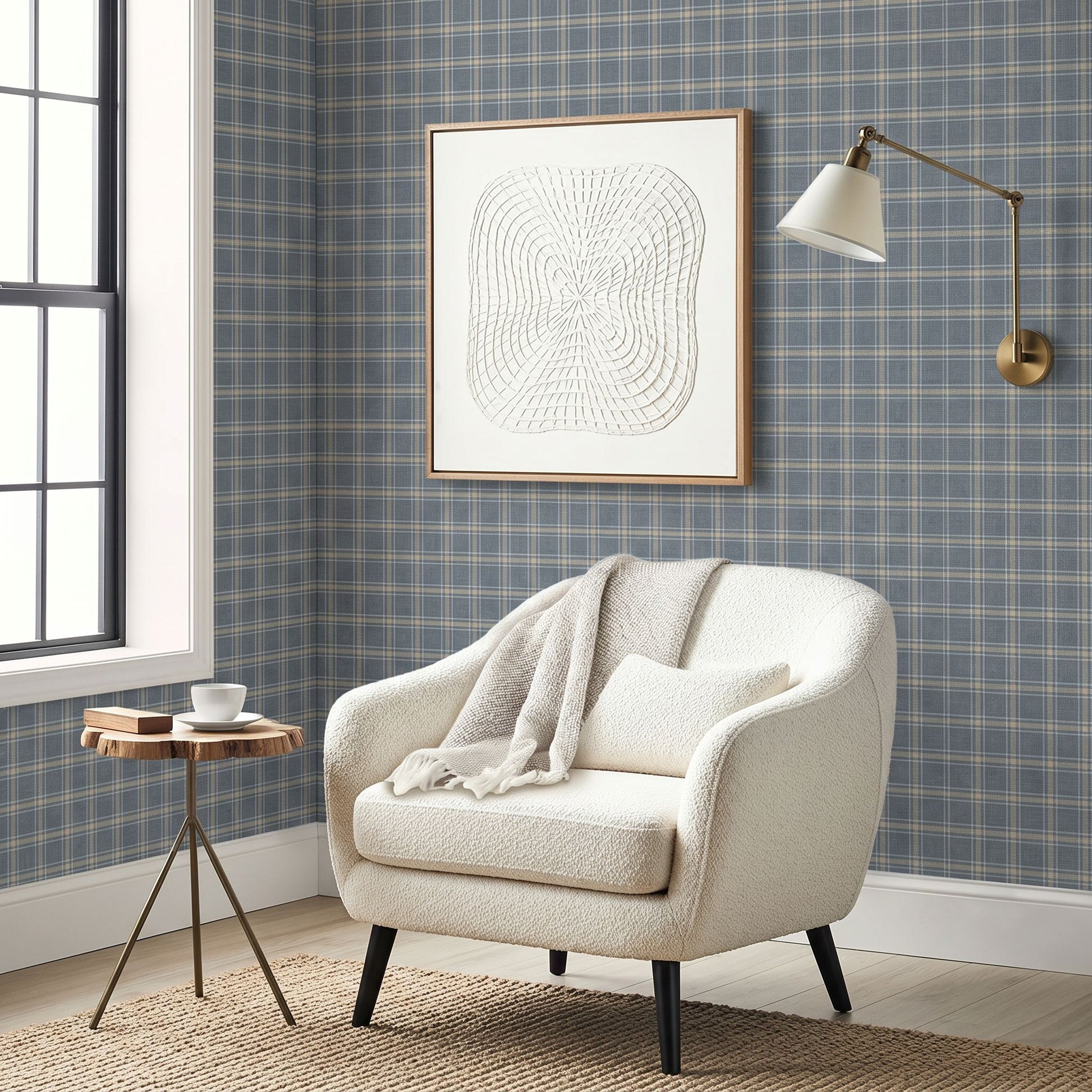 Cozy armchair with blanket, small round table, wall art, sconce, and Tartan Wallpaper in a country-style room.