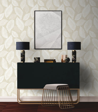 Modern interior design with a black console table, lamps, and decorative items against a wall decorated with Sand Cream Scattered Leaves Wallpaper.
