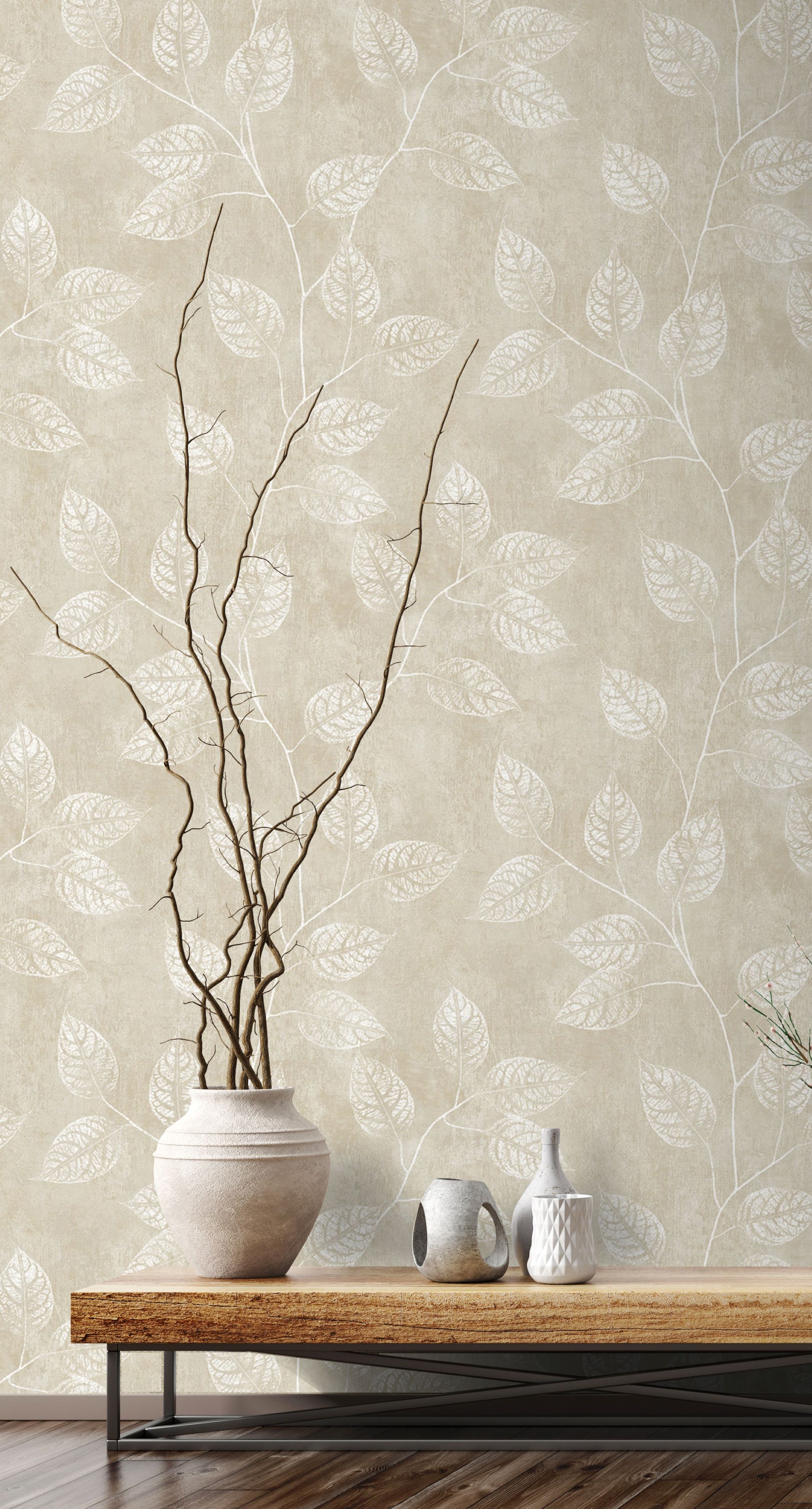 Wall decorated with Sand Yellow & Cream Branch Of Leaves Wallpaper, vase with branches, and small ceramic items on a wooden table.