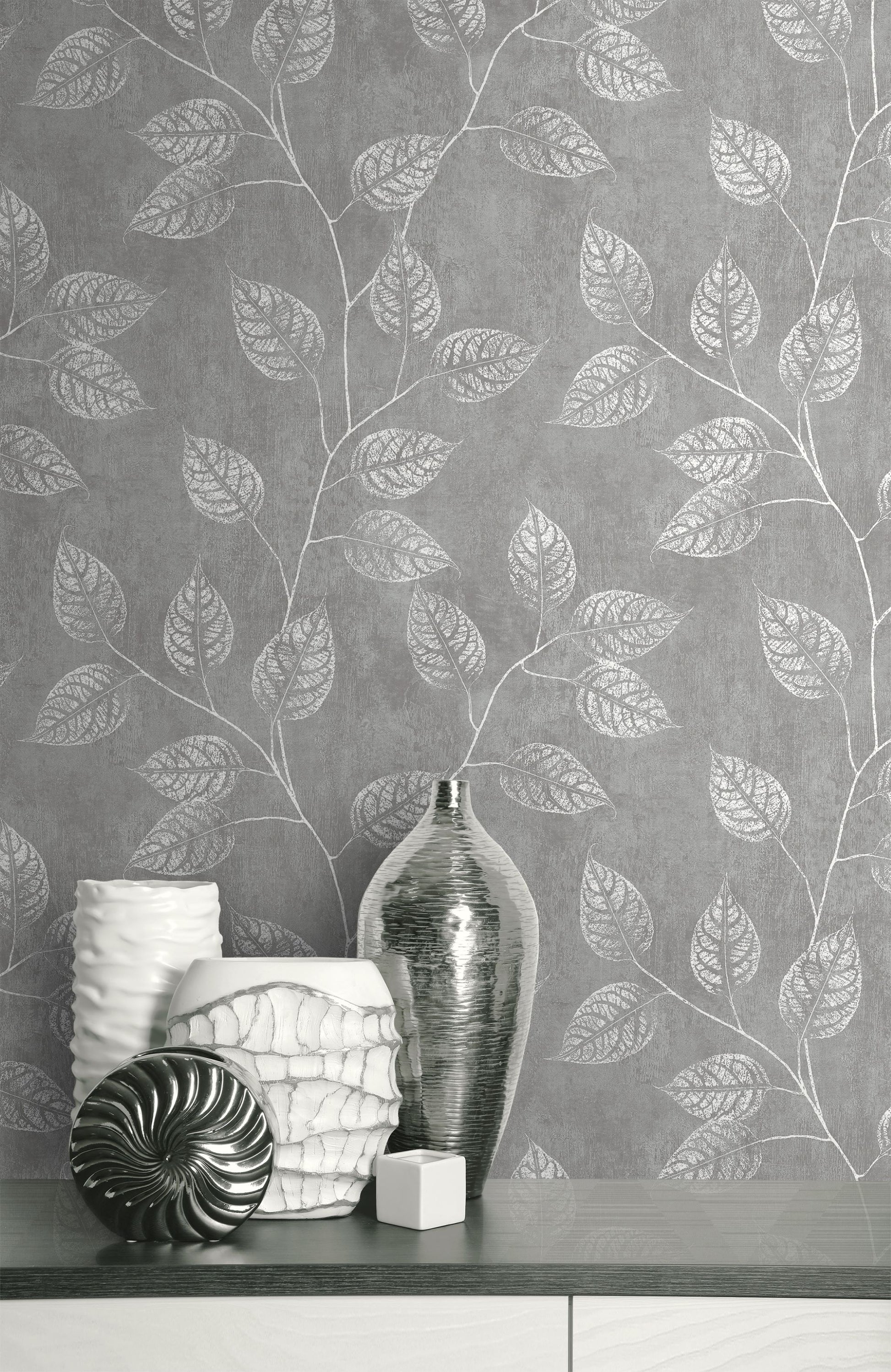 Wall decorated with Mist Gray Branch Of Leaves Wallpaper with decorative vases on a shelf.