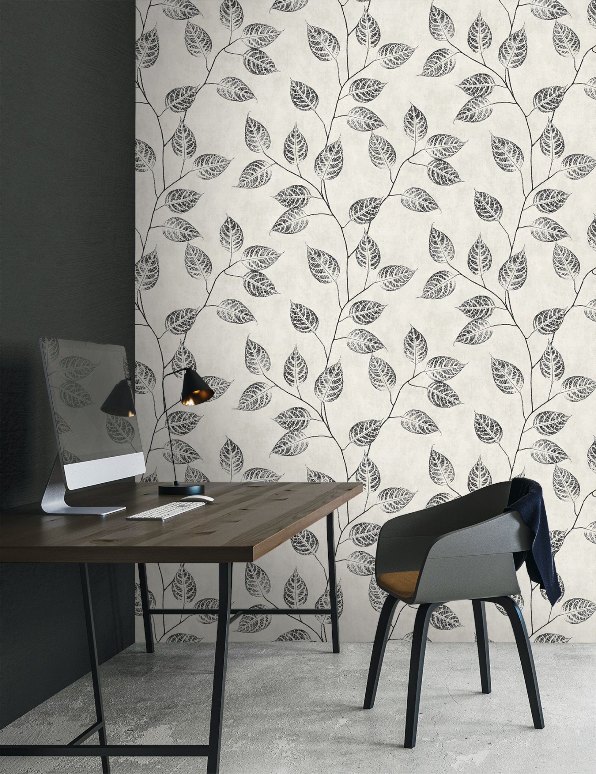 Modern office space with a desk and chair against a wall decorated with Black & Beige Branch Of Leaves Wallpaper.
