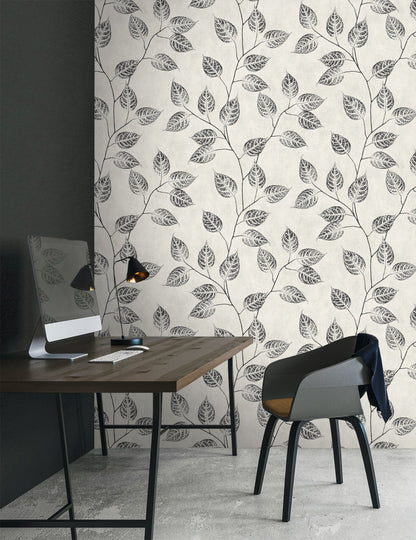 Modern office space with a desk and chair against a wall decorated with Black & Beige Branch Of Leaves Wallpaper.
