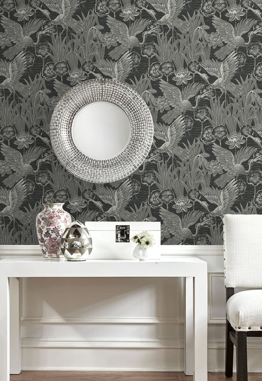 Decorative room with wall decorated with Black Marsh Heron Wallpaper, white table, and vase.