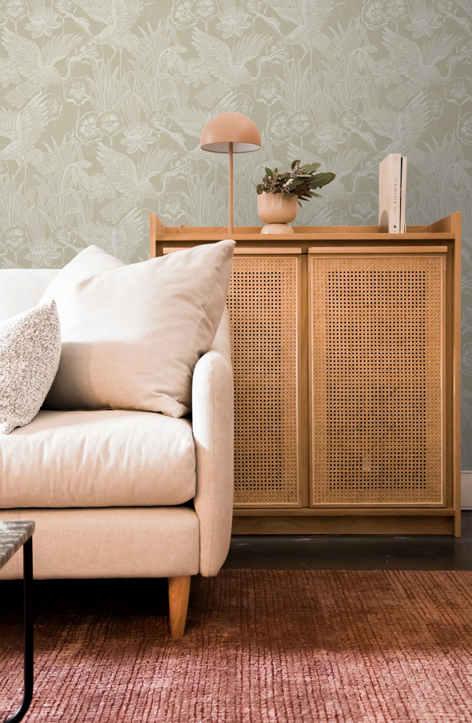 Living room with beige sofa, wooden cabinet, and wall decorated with Beige Marsh Heron Wallpaper.
