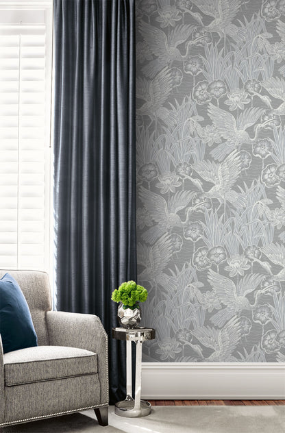 Living room with gray sofa, decorative plant, and a wall decorated with Gray Marsh Heron Wallpaper.
