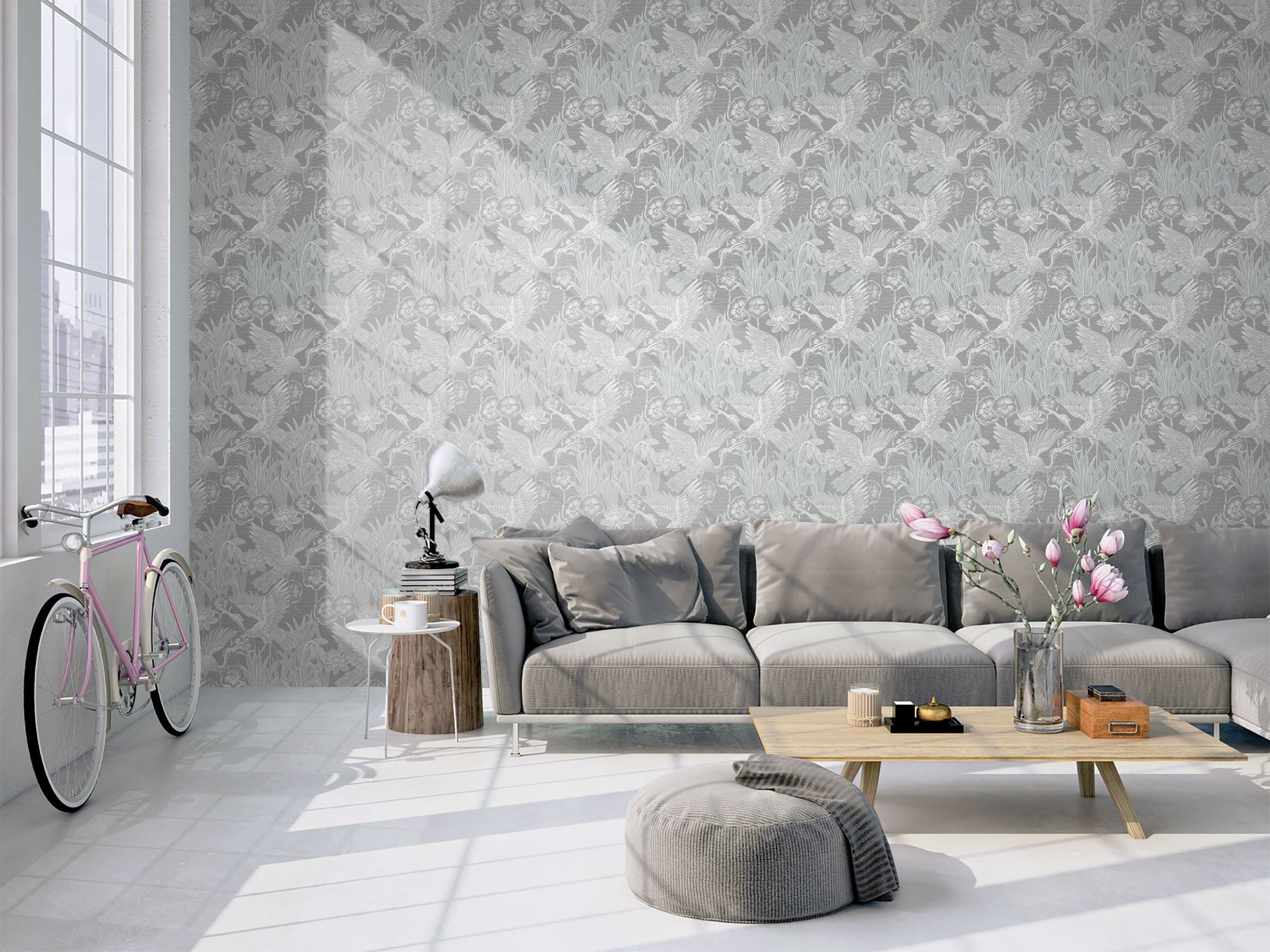 Modern living room with a gray sectional sofa, coffee table, and decorative elements against a wall decorated with Gray Marsh Heron Wallpaper.
