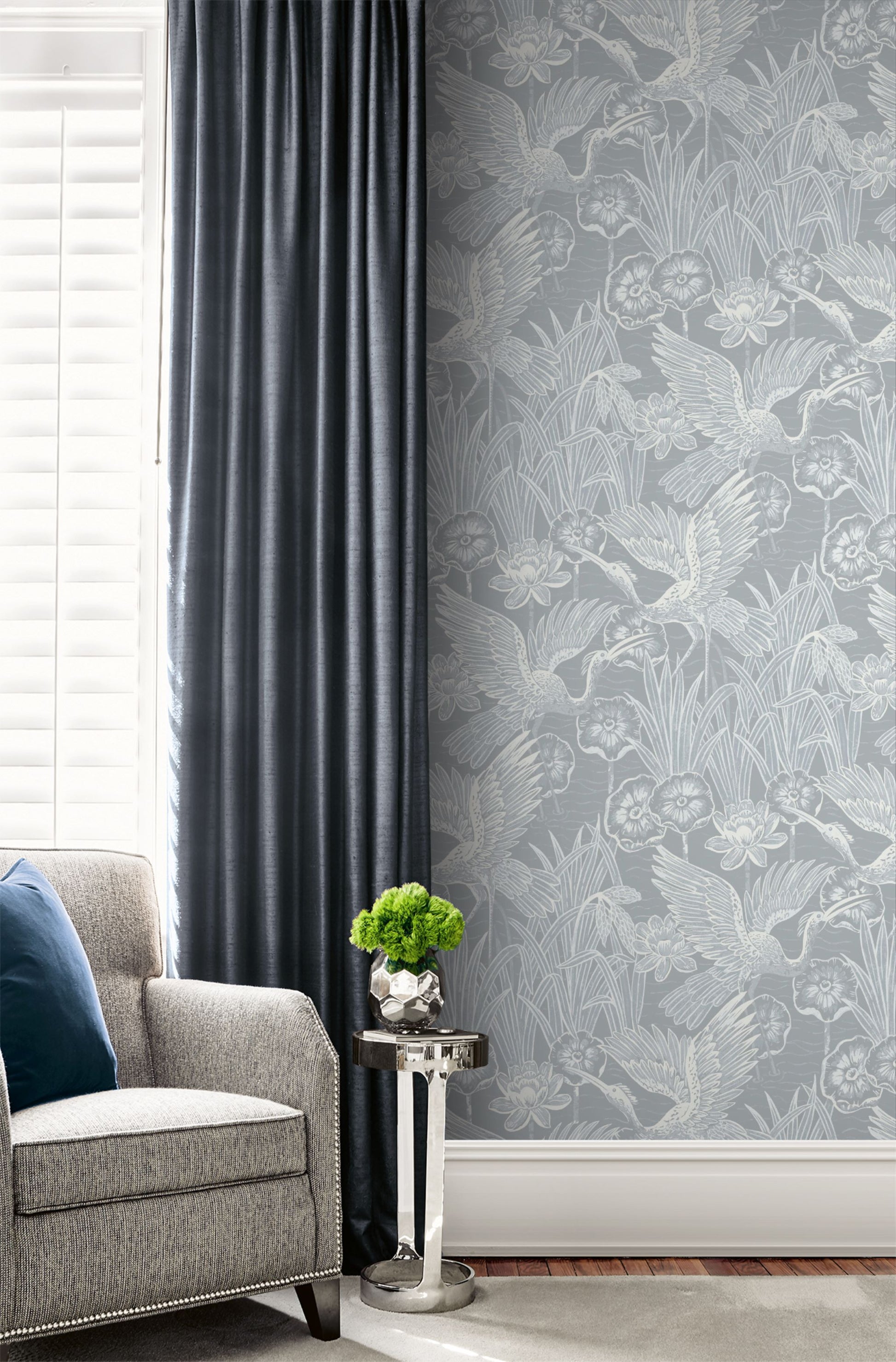 Living room with a wall decorated with Blue Marine Marsh Heron Wallpaper, dark gray curtain, and gray sofa.