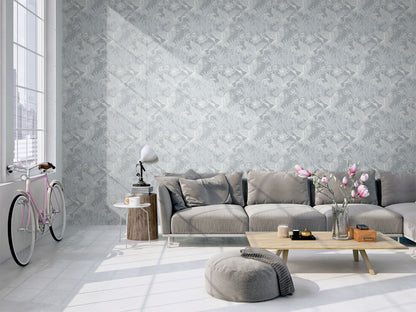 Modern living room with a gray sectional sofa, coffee table, and decorative elements against a wall decorated with Blue Marine Marsh Heron Wallpaper.
