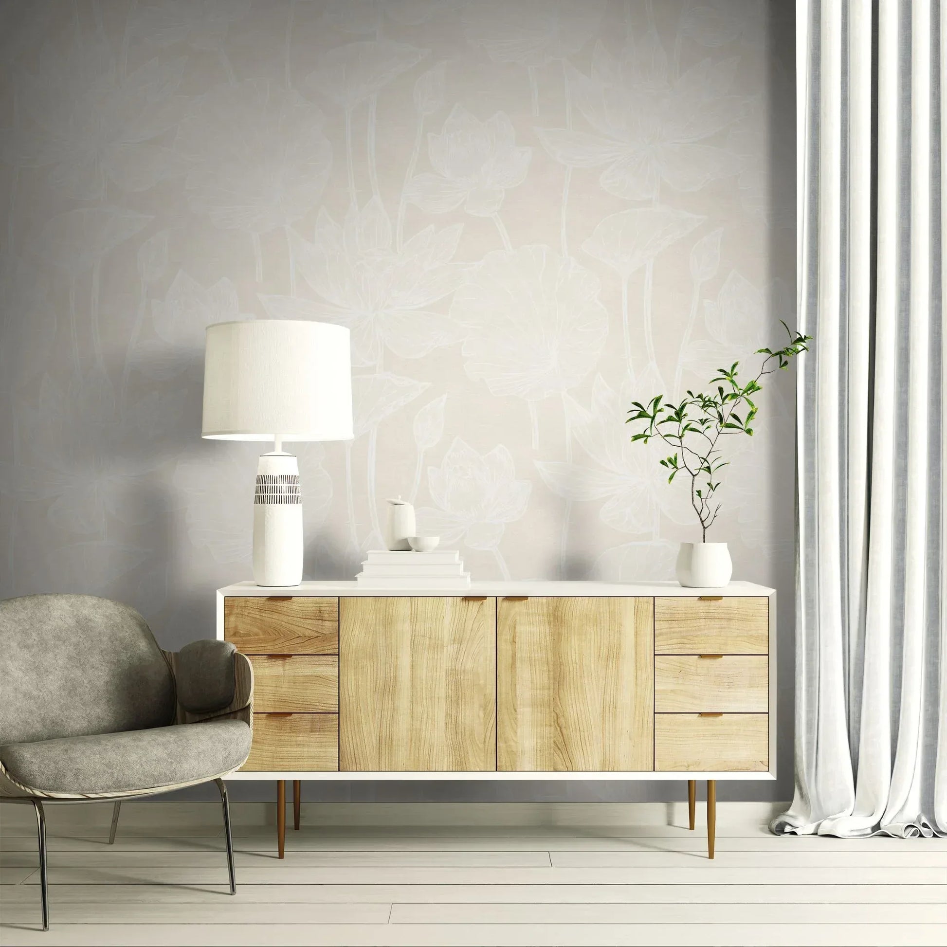 Modern living room with a wooden sideboard, gray chair, and Lily Flower Wallpaper behind a lamp and potted plant.