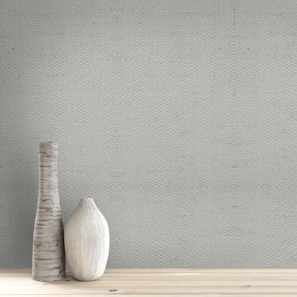 Two wooden vases on a wooden surface with a textured Gray & White/Off White Raffia Texture Grasscloth & Naturals wall in the background.