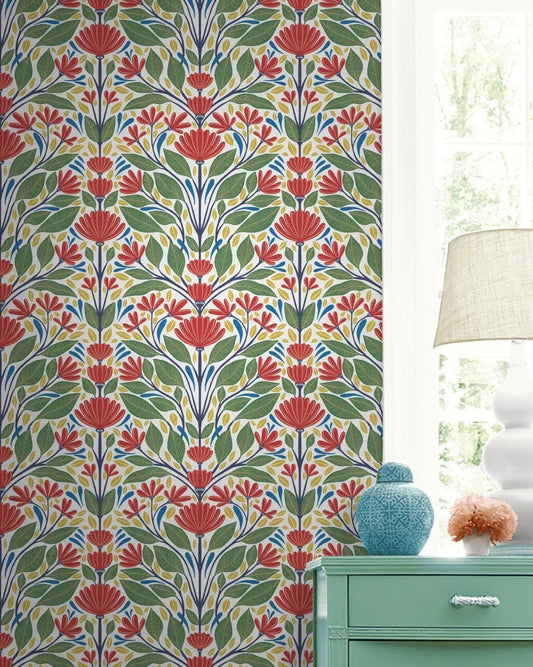 Painted Floral Wallpaper with red, green, and blue pattern beside a window, lamp, and turquoise dresser with decor.