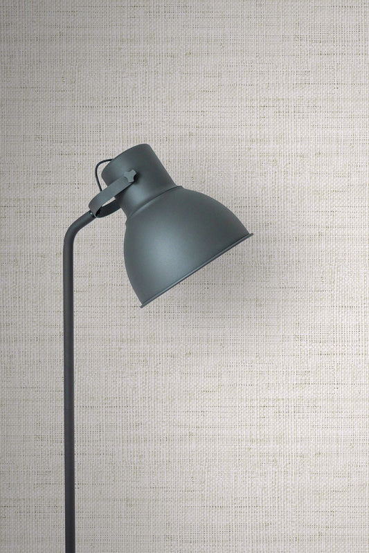 Dark gray wall lamp against a wall decorated with Pebble Linen Fabric Commercial & Vinyl.
