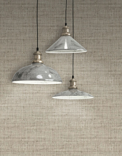 Three industrial-style pendant lights hanging against a wall decorated with Soft Brown Linen Fabric Commercial & Vinyl.
