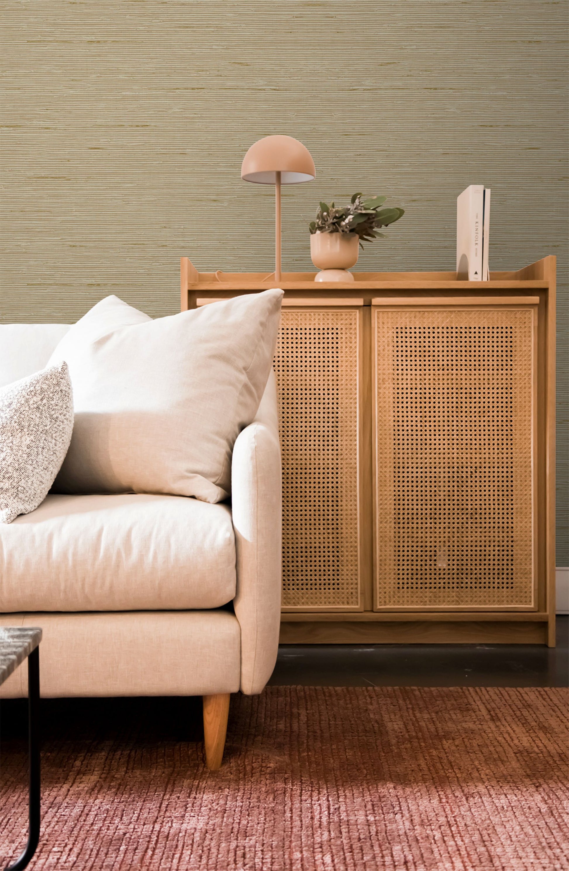 Beige sofa with decorative pillows and a wooden cabinet with wicker doors against a Parchment Beige Natural Weave Commercial & Vinyl.

