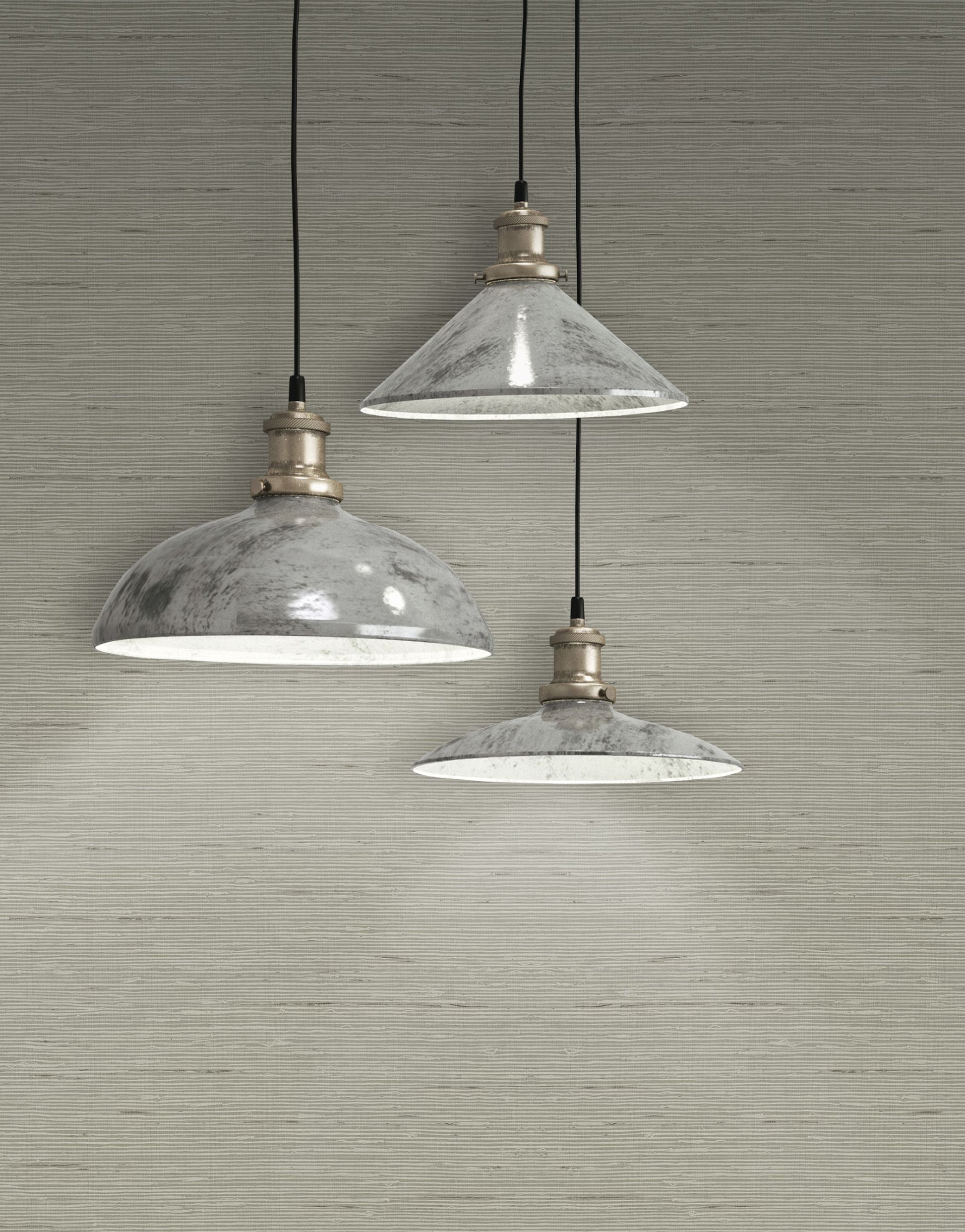Three pendant lights with glass shades hanging against a wall decorated with Mist Gray Natural Weave Commercial & Vinyl.
